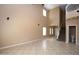 Open floor plan living room with high ceilings and tile flooring, flowing to stairs and entry at 2213 W Marconi Ave, Phoenix, AZ 85023