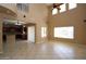 Open floor plan living room with high ceilings and tile flooring, flowing into kitchen at 2213 W Marconi Ave, Phoenix, AZ 85023