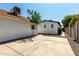 Backyard featuring a large concrete pad with a stone-lined path leading to a matching white house at 2221 N Richland St, Phoenix, AZ 85006