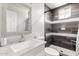 Modern bathroom with gray tiled shower, mosaic accents, and white vanity with decorative mirror at 2221 N Richland St, Phoenix, AZ 85006