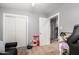 Bright bedroom featuring hardwood floors, sliding closet doors, and neutral gray paint at 2221 N Richland St, Phoenix, AZ 85006