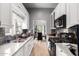 Galley kitchen featuring white cabinets, granite countertops, and stainless steel appliances at 2221 N Richland St, Phoenix, AZ 85006