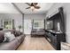 Comfortable living room with wood flooring, ceiling fan, and large-screen TV at 2221 N Richland St, Phoenix, AZ 85006