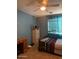 Comfortable bedroom with desk, dresser, ceiling fan and good natural light at 23890 W Twilight Trl, Buckeye, AZ 85326