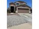 Attractive two-story home with a two-car garage and low-maintenance desert landscaping at 23890 W Twilight Trl, Buckeye, AZ 85326
