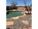 An inviting backyard pool is surrounded by decorative stones, offering a refreshing outdoor retreat at 23890 W Twilight Trl, Buckeye, AZ 85326