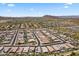 An aerial view of a desert community showcasing modern homes with tile roofs, desert landscaping, and open spaces at 26943 N 74Th Ave, Peoria, AZ 85383