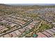 A desert community featuring modern homes with tile roofs, backyard pools, and desert landscaping from an aerial view at 26943 N 74Th Ave, Peoria, AZ 85383