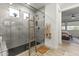 Modern bathroom featuring a glass shower with a wooden ladder and a view through to an open bedroom at 26943 N 74Th Ave, Peoria, AZ 85383
