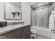 Clean bathroom with modern fixtures, a shower-tub combo, and neutral finishes at 26943 N 74Th Ave, Peoria, AZ 85383