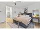 Stylish bedroom with a gray upholstered bed frame, modern ceiling fan, and natural wood accent pieces at 26943 N 74Th Ave, Peoria, AZ 85383
