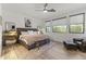 Modern bedroom with stylish furniture, ceiling fan, and natural light from the window at 26943 N 74Th Ave, Peoria, AZ 85383