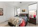 Bright bedroom with a large closet, neutral walls, wood-look tile floor, and a stylish platform bed frame at 26943 N 74Th Ave, Peoria, AZ 85383