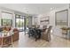 Dining room with a modern table, stylish decor, and bright windows with a view of the pool at 26943 N 74Th Ave, Peoria, AZ 85383