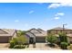 Exterior shot of a single-Gathering home with desert landscaping and a two-car garage at 26943 N 74Th Ave, Peoria, AZ 85383