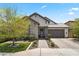 Beautiful single-story home featuring stone accents, a spacious driveway, manicured lawn, and a two-car garage at 26943 N 74Th Ave, Peoria, AZ 85383