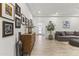 Hallway featuring stylish wood-look tile floor, neutral paint, and attractive decor and furniture at 26943 N 74Th Ave, Peoria, AZ 85383