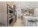 Modern kitchen with stainless steel appliances and quartz countertop island at 26943 N 74Th Ave, Peoria, AZ 85383