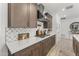 Contemporary kitchen design with quartz countertops and stylish tile backsplash at 26943 N 74Th Ave, Peoria, AZ 85383
