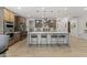 Bright kitchen with large quartz island, seating, pendant lights, and stainless appliances at 26943 N 74Th Ave, Peoria, AZ 85383
