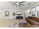 Cozy living room featuring a comfortable leather sectional, stylish decor, and wood-look tile flooring at 26943 N 74Th Ave, Peoria, AZ 85383