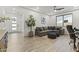Spacious living room with a comfortable sectional couch, modern tile floors, and a tall indoor tree at 26943 N 74Th Ave, Peoria, AZ 85383