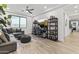 Spacious living room with ample seating, recessed lighting, and wood-look tile flooring at 26943 N 74Th Ave, Peoria, AZ 85383
