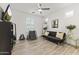 Versatile living space with ample natural light, modern fan, and wood-look tile flooring at 26943 N 74Th Ave, Peoria, AZ 85383