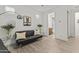 Stylish living area featuring a comfortable sofa, modern decor, and convenient access to an adjacent bathroom at 26943 N 74Th Ave, Peoria, AZ 85383
