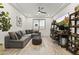 Inviting living area featuring a comfortable gray sectional sofa, a large TV, and neutral decor at 26943 N 74Th Ave, Peoria, AZ 85383