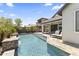 Sparkling pool with travertine decking and lounge chairs, perfect for relaxing outdoors at 26943 N 74Th Ave, Peoria, AZ 85383