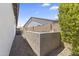 Side yard view with decorative gravel landscaping, a concrete block wall, and utility access at 26943 N 74Th Ave, Peoria, AZ 85383