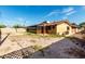 View of home's backyard featuring a covered patio, block fence, and desert landscaping at 3208 W Port Royale Ln, Phoenix, AZ 85053