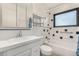 Bright bathroom featuring tiled walls, a vanity, a toilet, and a bath tub at 3208 W Port Royale Ln, Phoenix, AZ 85053