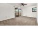 An empty bedroom with carpet flooring and sliding glass doors at 3208 W Port Royale Ln, Phoenix, AZ 85053