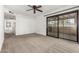 Empty bedroom with neutral carpeting and a sliding glass door at 3208 W Port Royale Ln, Phoenix, AZ 85053