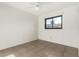 Bright bedroom featuring tile floors, a window, and a ceiling fan at 3208 W Port Royale Ln, Phoenix, AZ 85053