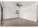 A bedroom with neutral carpet, white walls, and a ceiling fan at 3208 W Port Royale Ln, Phoenix, AZ 85053