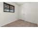 Bedroom featuring tile floors and a window at 3208 W Port Royale Ln, Phoenix, AZ 85053