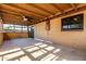 Covered patio with concrete floors, a ceiling fan and brick exterior at 3208 W Port Royale Ln, Phoenix, AZ 85053