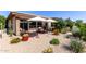 Backyard with patio seating and lush landscaping at 35990 N Desert Tea Dr, Queen Creek, AZ 85140