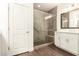 Modern bathroom features a glass-enclosed shower with seating and white cabinetry at 35990 N Desert Tea Dr, Queen Creek, AZ 85140