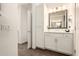 Bathroom featuring white cabinets, granite countertops, and modern lighting at 35990 N Desert Tea Dr, Queen Creek, AZ 85140