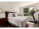 Well-lit bedroom features wood floors, and a large window with backyard views at 35990 N Desert Tea Dr, Queen Creek, AZ 85140