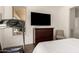 Bedroom featuring a dresser, a treadmill, and a view of the back patio at 35990 N Desert Tea Dr, Queen Creek, AZ 85140