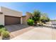 View of the exterior and garage, showcasing a desert landscape with an enclosed garage at 35990 N Desert Tea Dr, Queen Creek, AZ 85140