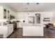 Bright kitchen with white cabinets, stainless steel appliances, and island seating at 35990 N Desert Tea Dr, Queen Creek, AZ 85140