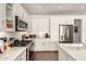 Modern kitchen with white cabinets, stainless steel appliances, and sleek countertops at 35990 N Desert Tea Dr, Queen Creek, AZ 85140