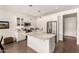 Modern kitchen featuring white cabinetry, stainless steel appliances, and a large island at 35990 N Desert Tea Dr, Queen Creek, AZ 85140