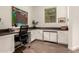 Functional home office features built-in desk with storage and a view to the exterior at 35990 N Desert Tea Dr, Queen Creek, AZ 85140